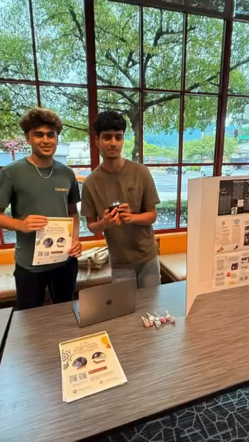 Two Flash Forward volunteers at a fundraising table