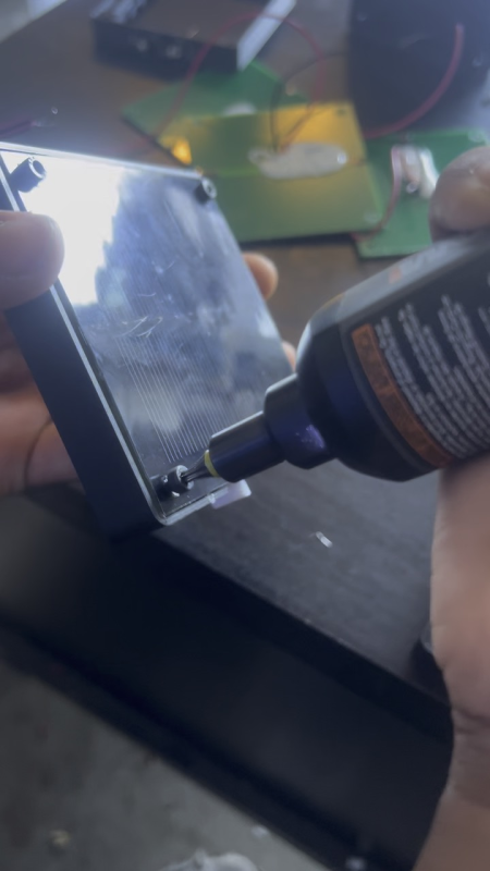 Volunteers screwing parts into solar study lights
