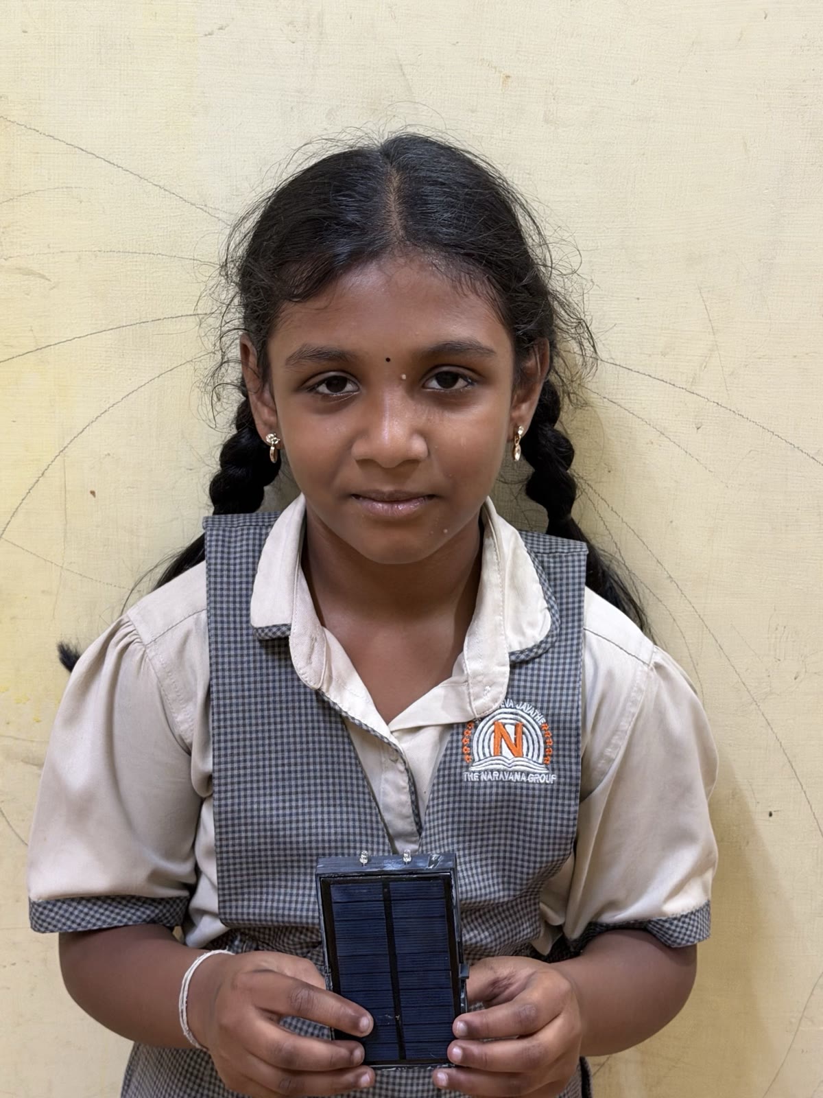 A student holding the solar flashlight she received