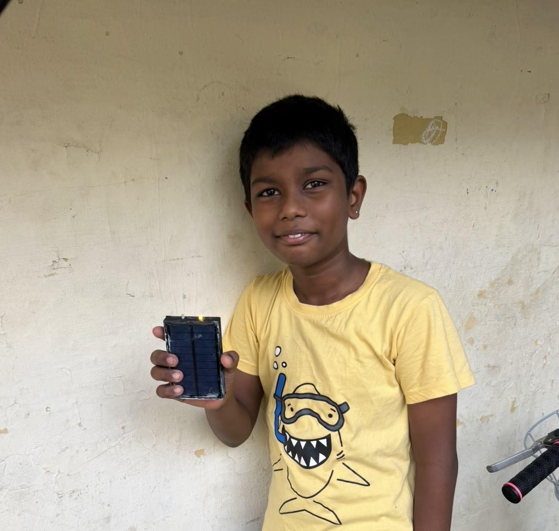 A student in India holding a Flash Forward study light